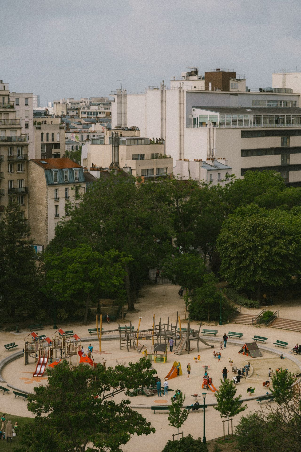 a playground in a city with lots of trees